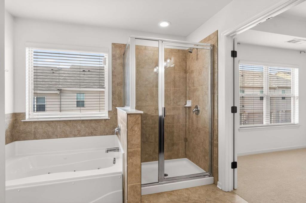 7631 Bucknell Terrace Fairburn, GA 30213 - Photo 24 of 43 a bathroom with a bathtub and a shower