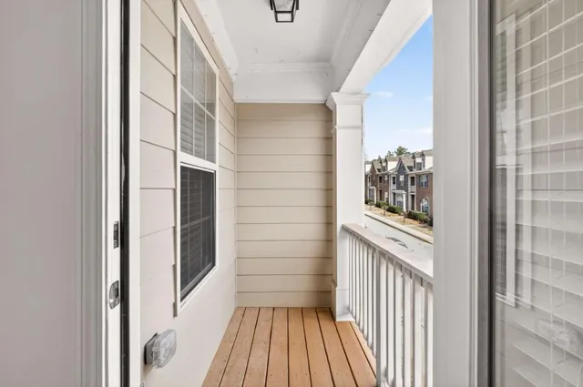 a view of a hallway with wooden floor and a window