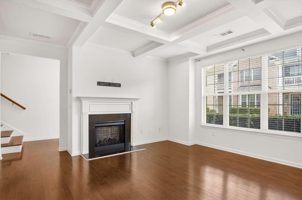 7631 Bucknell Terrace Fairburn, GA 30213 - Photo 7 of 43 a view of an empty room with wooden floor fireplace and a window