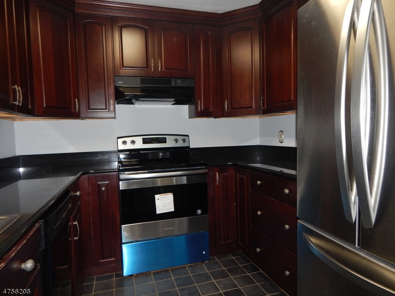54 Wescott Road Bedminster, NJ 07921 - Photo 1 of 9 a kitchen with granite countertop stainless steel appliances and wooden cabinets