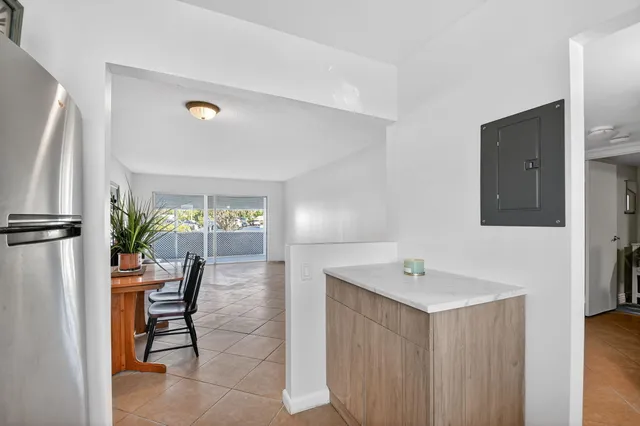 a view of a hallway with wooden floor and door