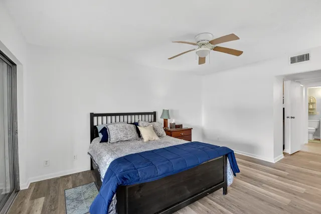 a view of swimming pool with outdoor seating and a forest