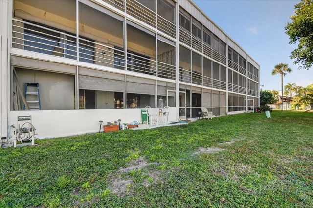 a view of a house with a yard and potted plants
