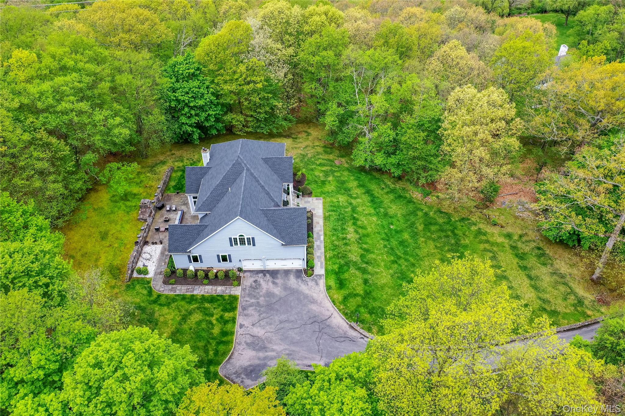 630 Chappaqua Road Briarcliff Manor, NY 10510 - Photo 38 of 41 Side aerial view showcasing the attached 3-car garage, expansive driveway, and impressive estate setting