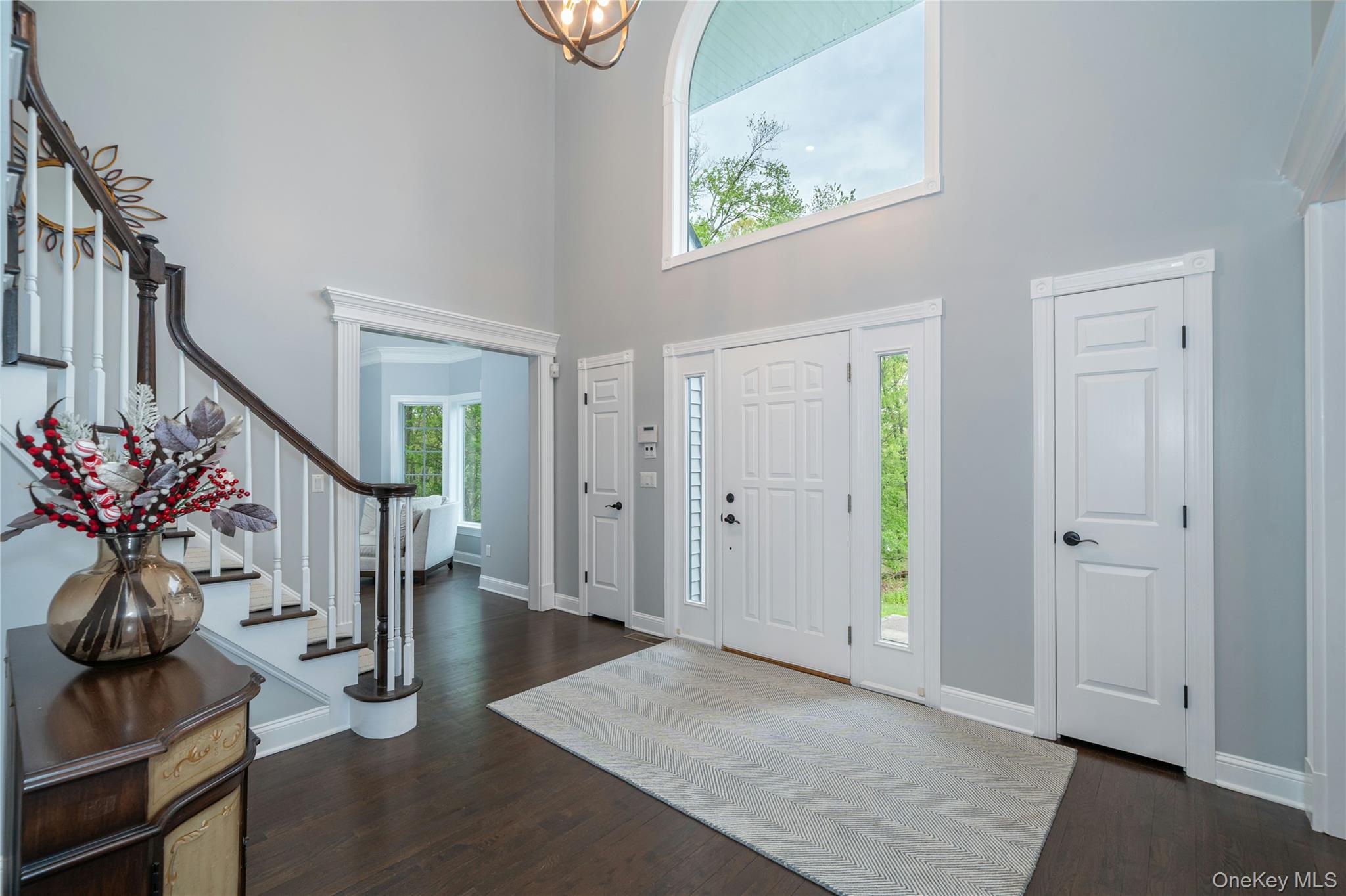 630 Chappaqua Road Briarcliff Manor, NY 10510 - Photo 4 of 41 Grand double-height foyer with elegant staircase, custom millwork, and refinished hardwood floors