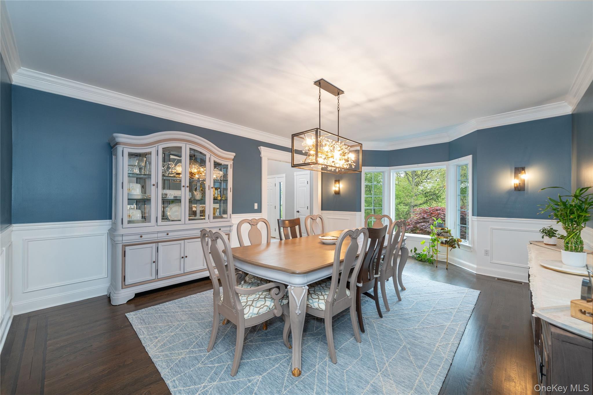 630 Chappaqua Road Briarcliff Manor, NY 10510 - Photo 8 of 41 Elegant formal dining room featuring detailed custom millwork, wainscoting, and refinished hardwood floors