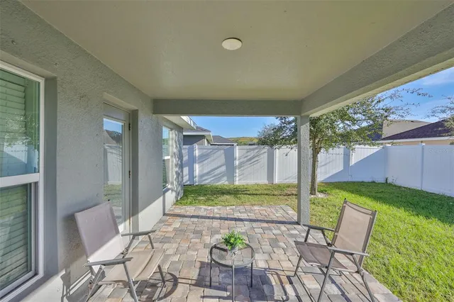 a view of an chairs and table in patio