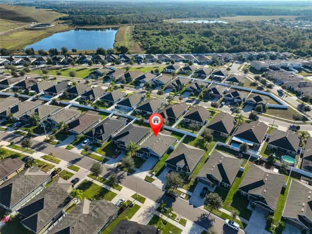 an aerial view of residential houses with outdoor space