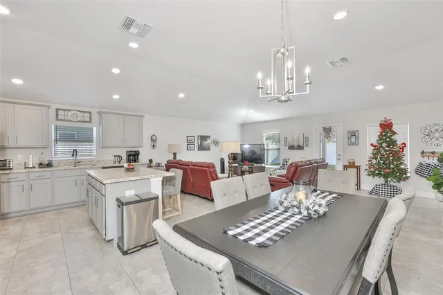 a large kitchen with cabinets table and chairs