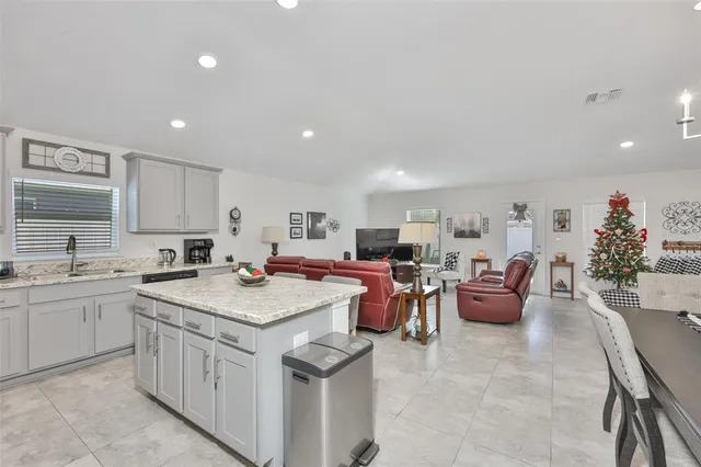a kitchen that has a lot of cabinets a sink and a stove in it