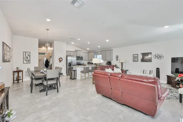 a living room with furniture kitchen and a kitchen view