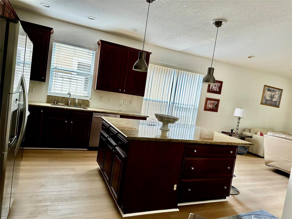 8564 Vía Giardino Boca Raton, FL 33433 - Photo 16 of 20 a kitchen with a sink and a mirror