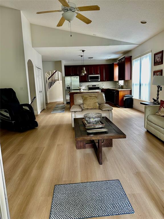 8564 Vía Giardino Boca Raton, FL 33433 - Photo 17 of 20 a living room with furniture a wooden floor and chandelier