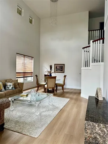 a living room with furniture rug and a window