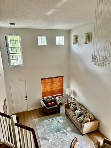 a living room with furniture a window and a flat screen tv