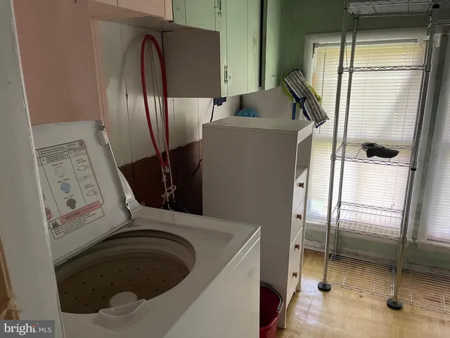 a bathroom with a sink toilet and window