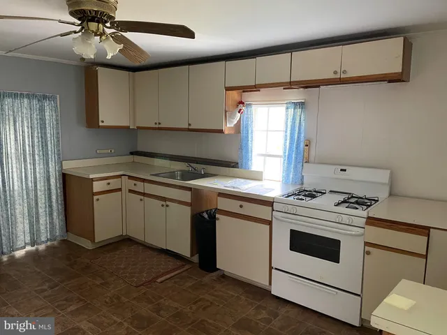 a view of empty room with window and wooden floor