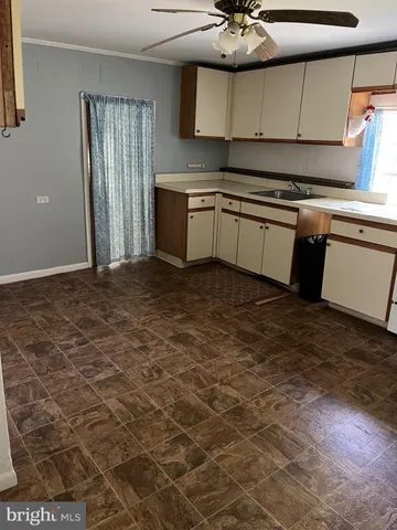 a room with wooden floor and white walls