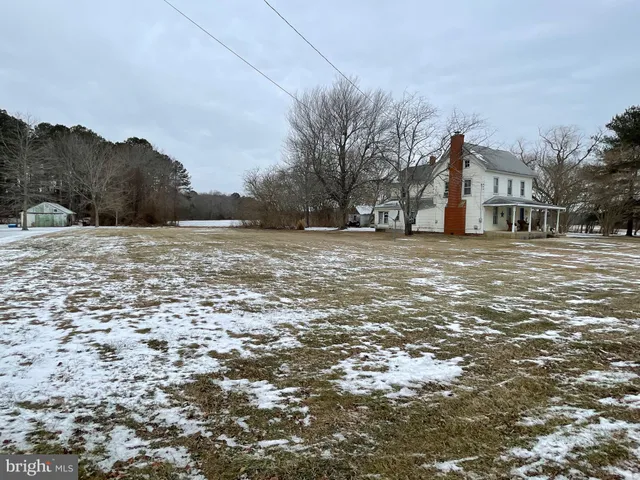 a view of a white house with a yard