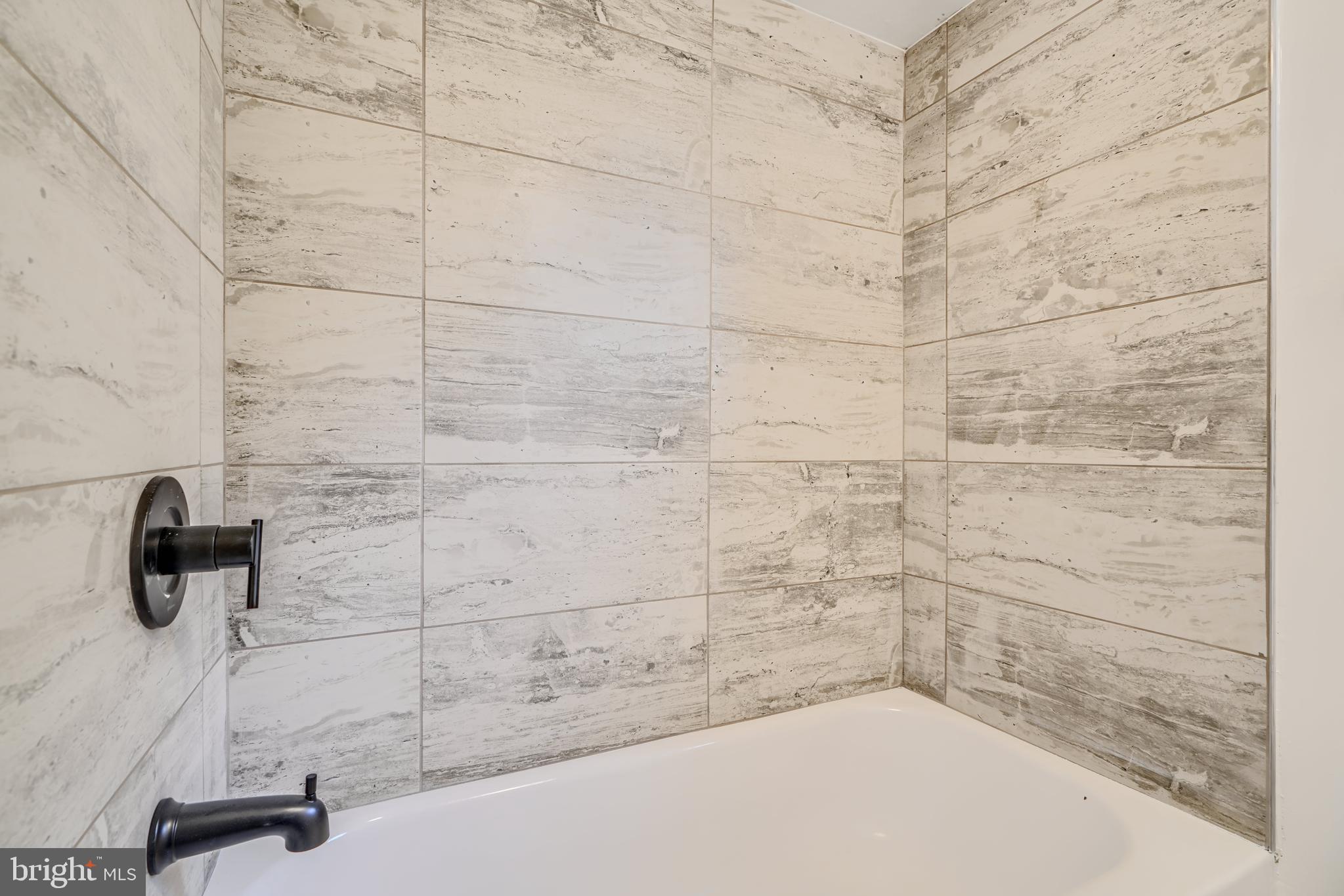 227 Elizabeth Avenue Baltimore, MD 21225 - Photo 12 of 31 a bathroom with a shower