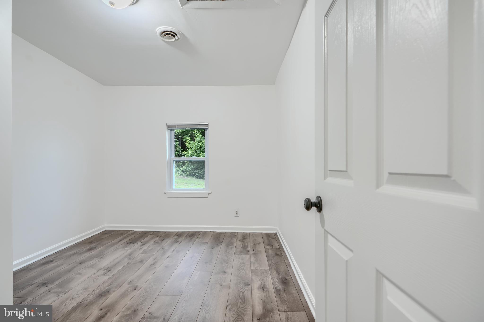 227 Elizabeth Avenue Baltimore, MD 21225 - Photo 14 of 31 a view of a hallway with wooden floor and closet