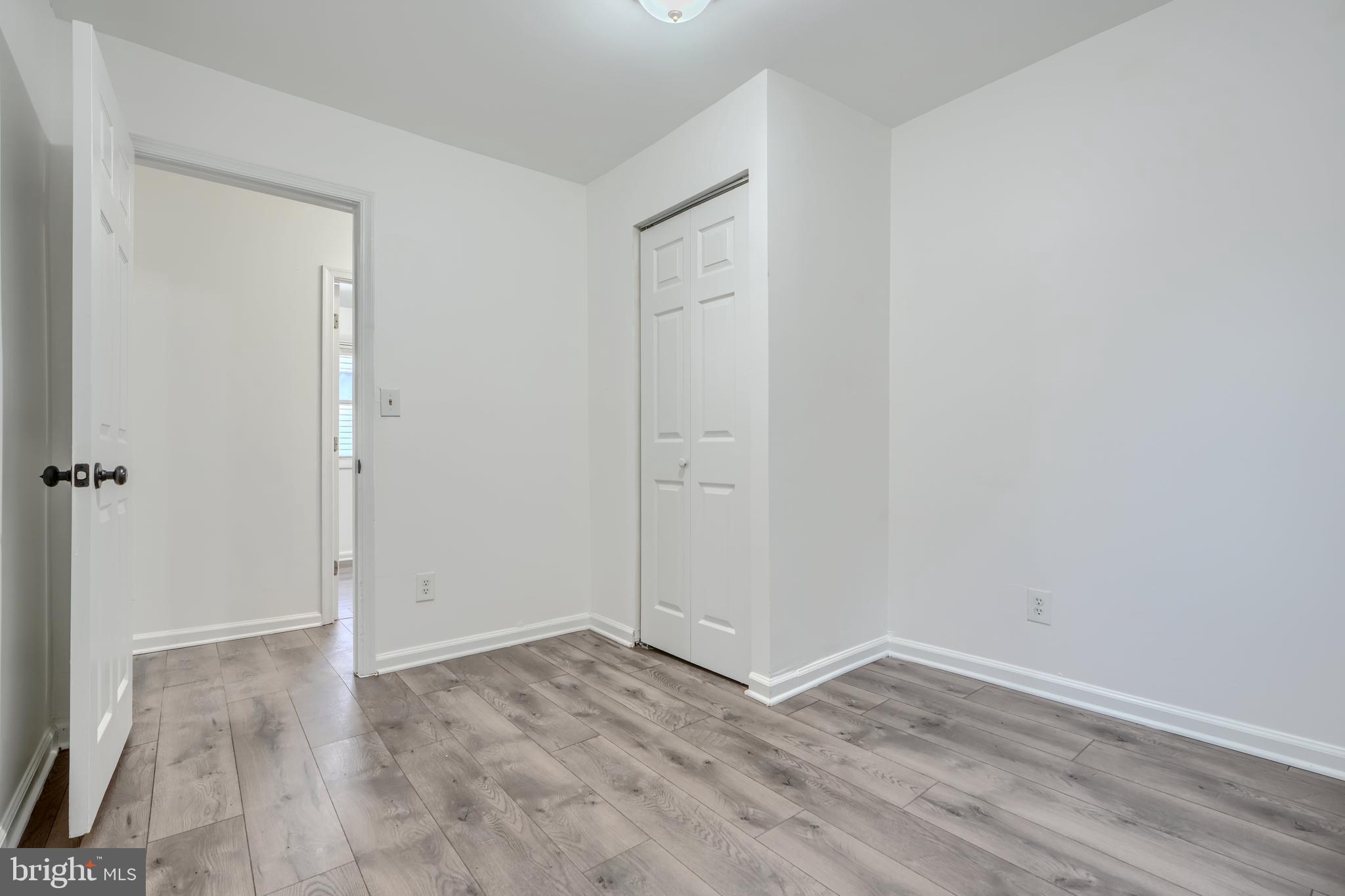 227 Elizabeth Avenue Baltimore, MD 21225 - Photo 16 of 31 wooden floor in an empty room