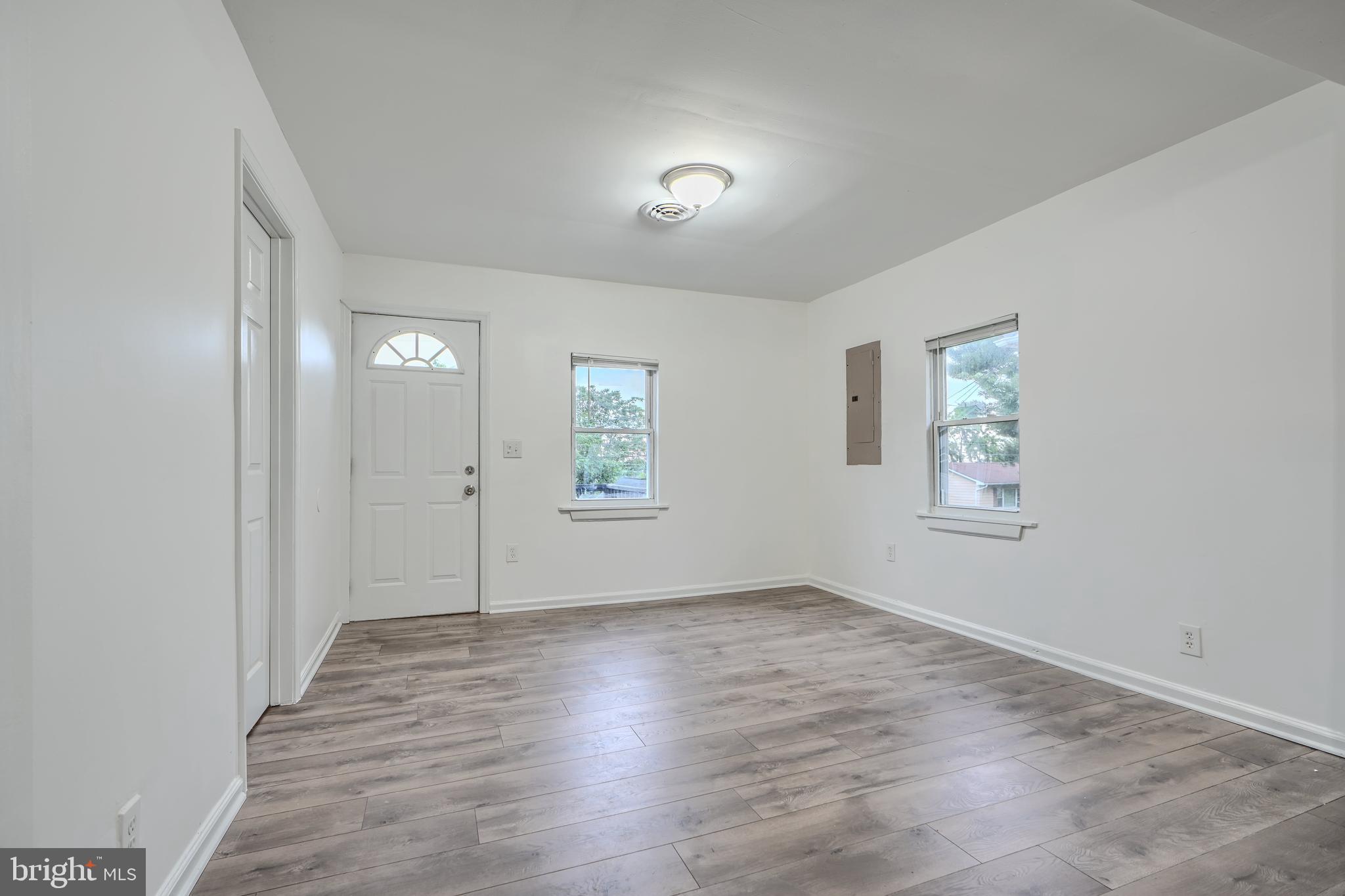 227 Elizabeth Avenue Baltimore, MD 21225 - Photo 23 of 31 wooden floor in an empty room with a window