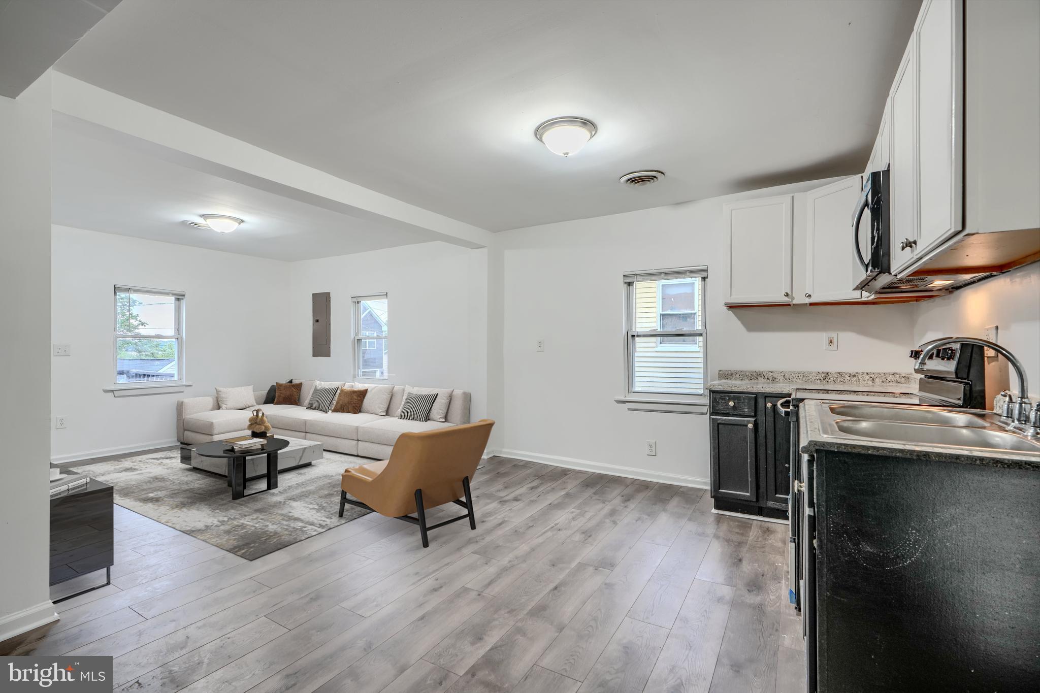 227 Elizabeth Avenue Baltimore, MD 21225 - Photo 4 of 31 a living room with furniture and a wooden floor