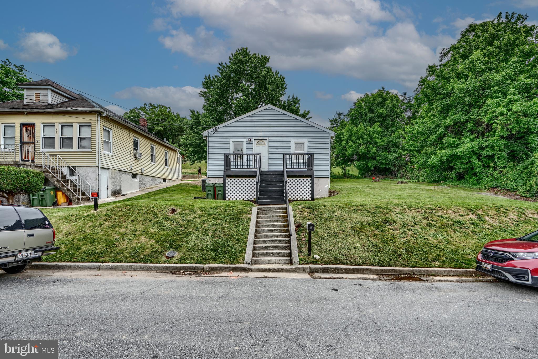 227 Elizabeth Avenue Baltimore, MD 21225 - Photo 6 of 31 a front view of a house with a yard and garage
