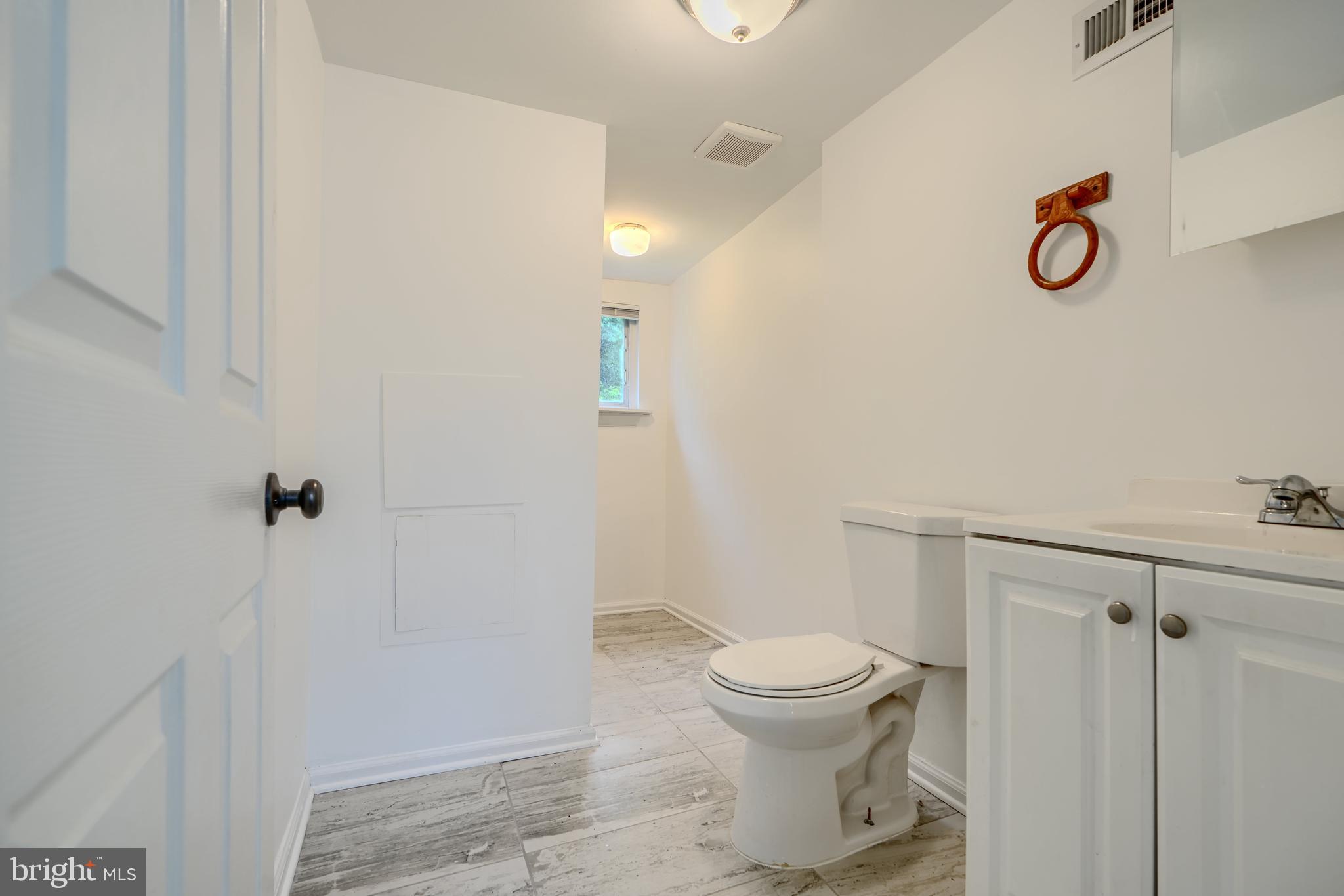 227 Elizabeth Avenue Baltimore, MD 21225 - Photo 10 of 31 a bathroom with a toilet and a shower