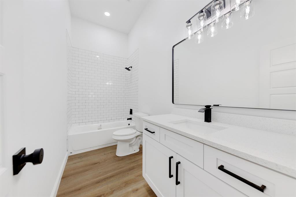 1269 Bonham Street Paris, TX 75460 - Photo 12 of 19 a bathroom with a sink a toilet and shower
