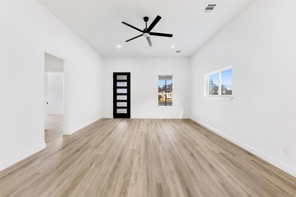 1269 Bonham Street Paris, TX 75460 - Photo 3 of 19 wooden floor in an empty room with a window