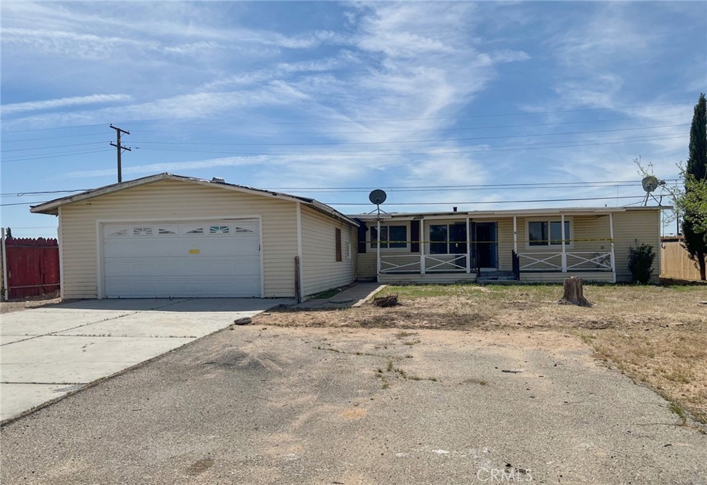 27154 Anderson Street Boron, CA 93516 - Photo 1 of 12 a front view of a house with a yard and garage