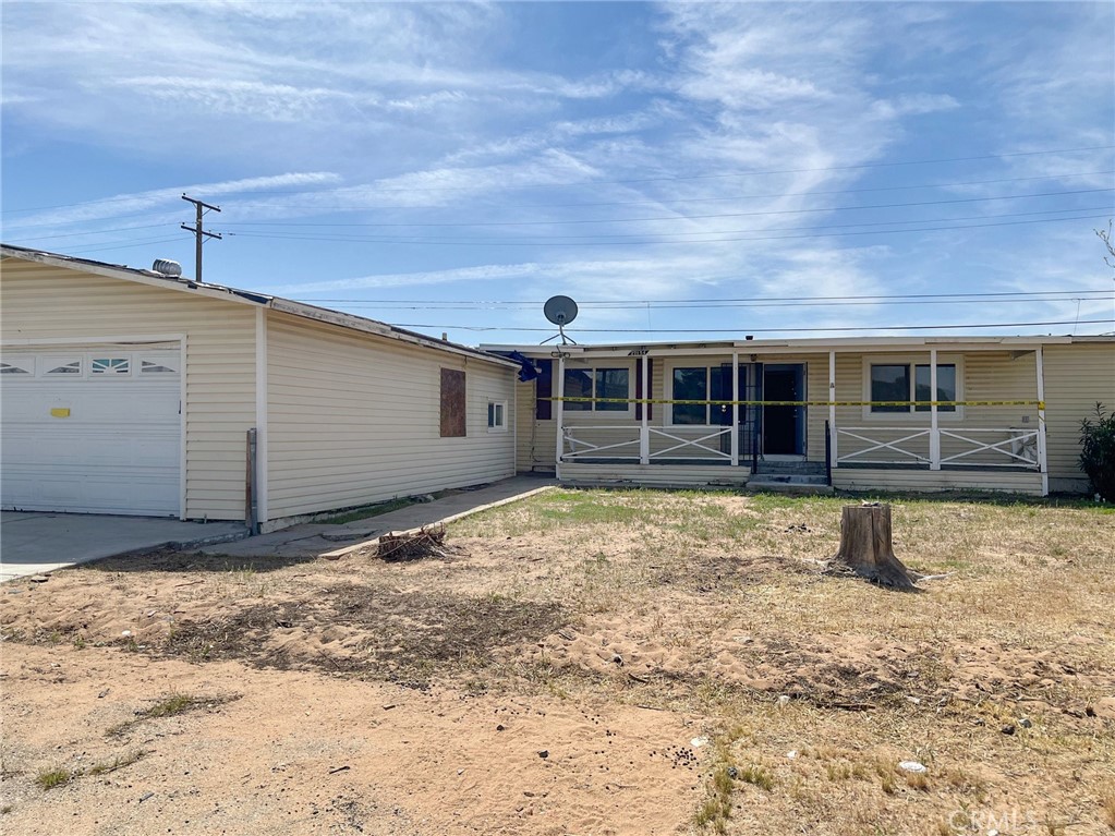 27154 Anderson Street Boron, CA 93516 - Photo 2 of 12 a view of a house with a backyard