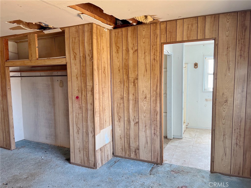 27154 Anderson Street Boron, CA 93516 - Photo 6 of 12 a view of a house with a wooden fence