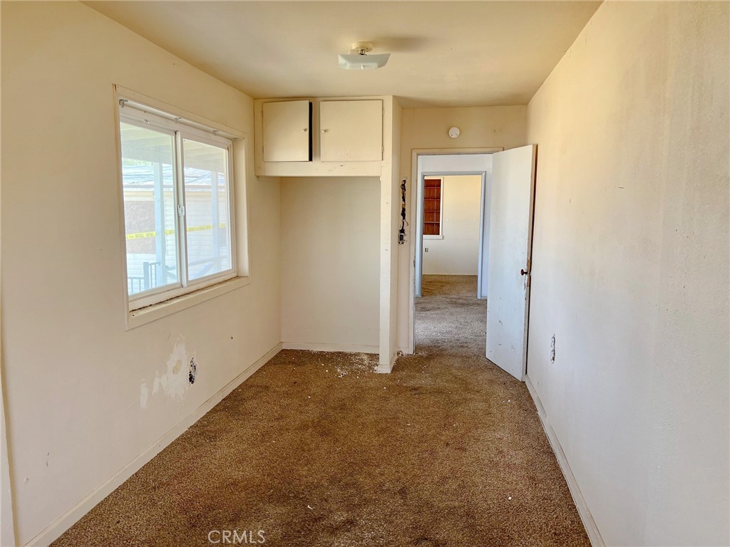 27154 Anderson Street Boron, CA 93516 - Photo 7 of 12 an empty room with windows and closet