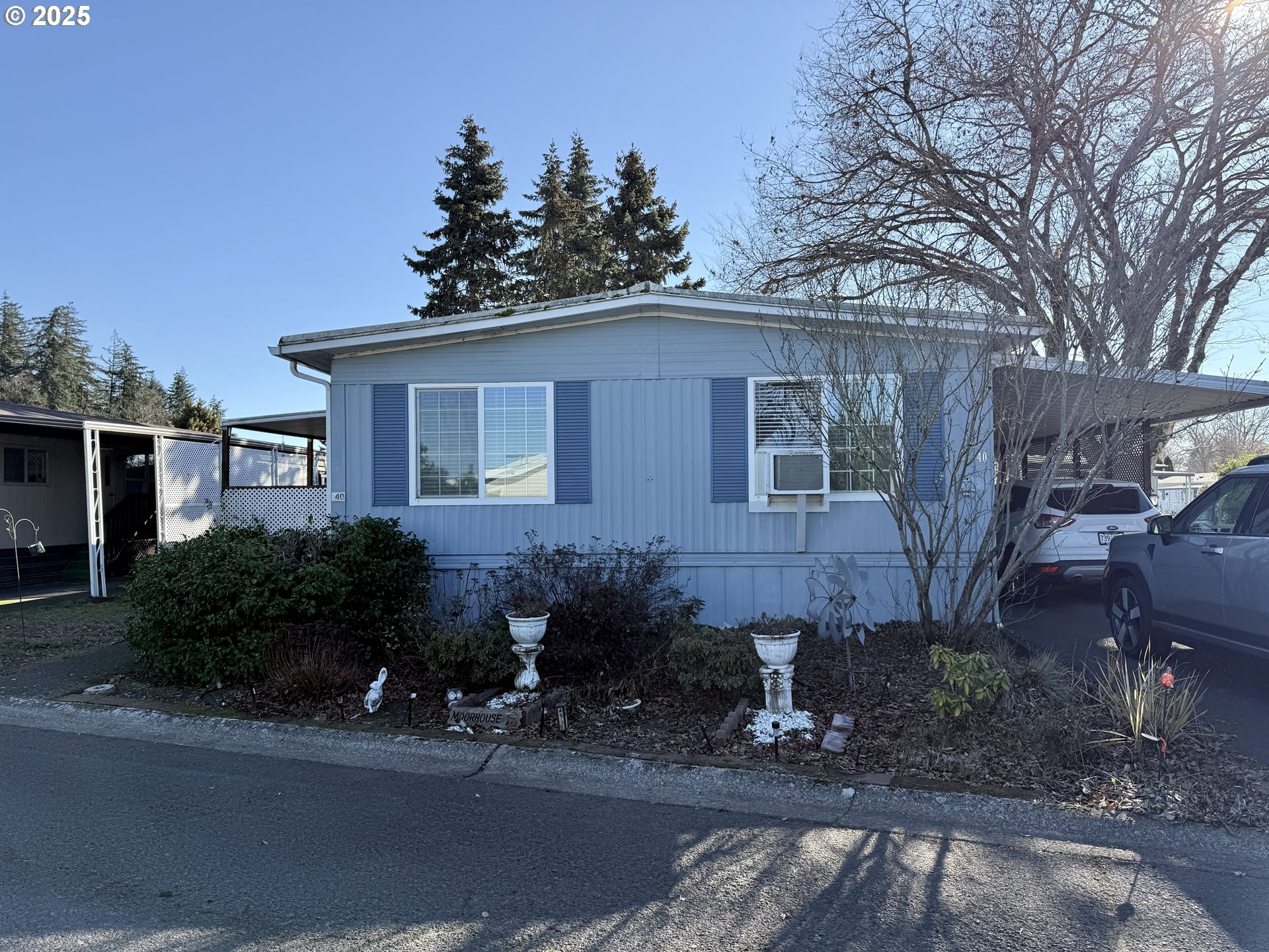 1475 Green Acres Road, Unit 40 Eugene, OR 97408 - Photo 2 of 30 a view of a house with a yard and plants