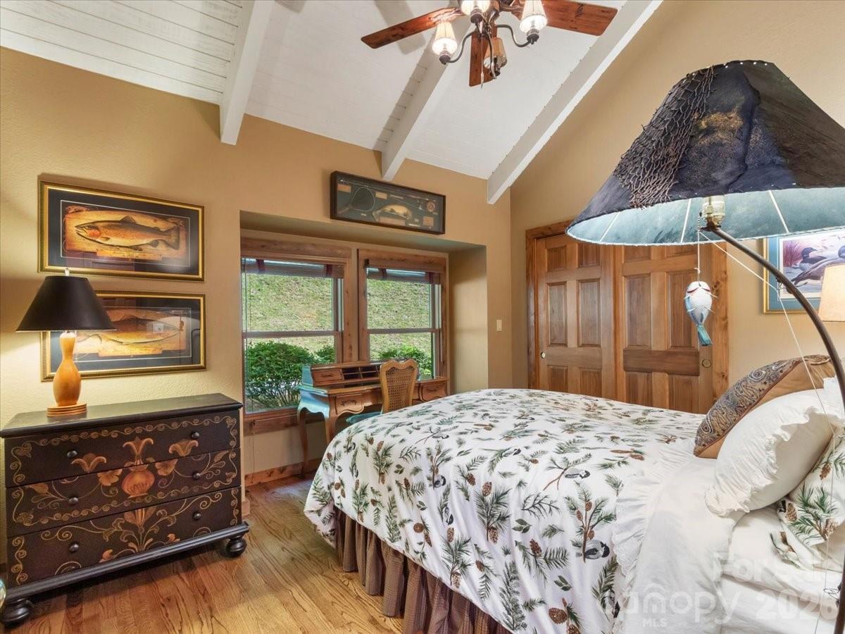 121 Ivy Ridge Road Burnsville, NC 28714 - Photo 27 of 48 a bedroom with a large bed and a window