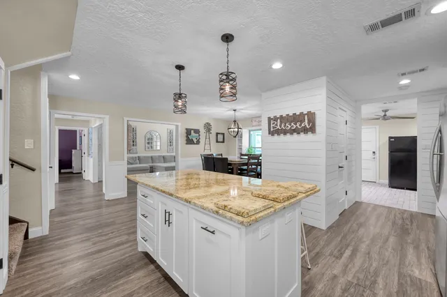 a kitchen with stainless steel appliances granite countertop a sink stove and cabinets