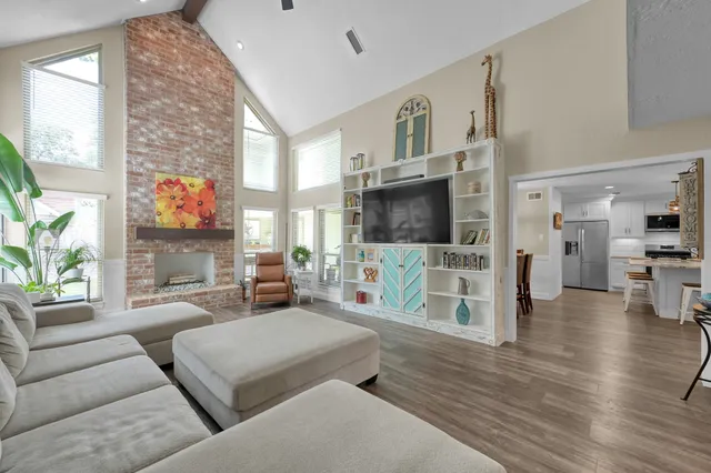 a living room with fireplace furniture and a flat screen tv