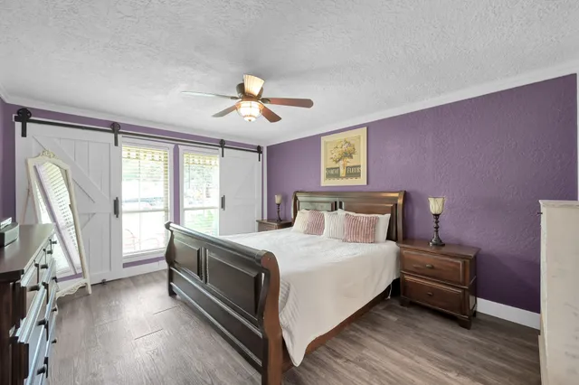a living room with furniture a flat screen tv and wooden floor
