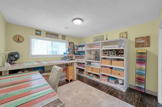 a bedroom with a bed and a desk