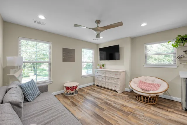 a kitchen with a table chairs refrigerator and microwave