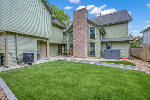 a front view of a house with a garden and yard