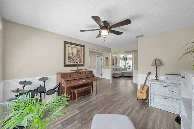 a living room with furniture a window and wooden floor