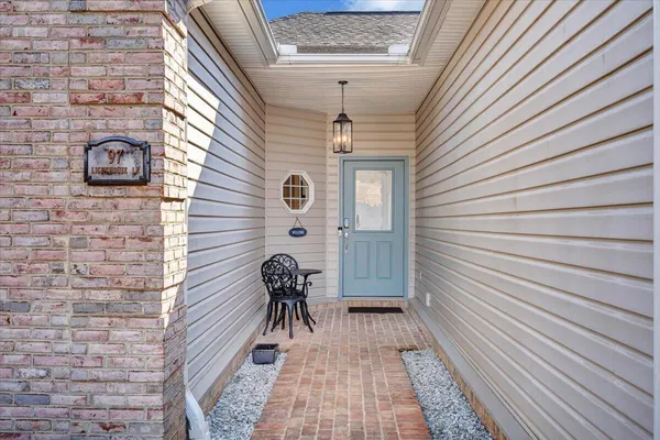 a large kitchen with stainless steel appliances granite countertop a stove top oven a sink dishwasher a dining table and chairs with wooden floor