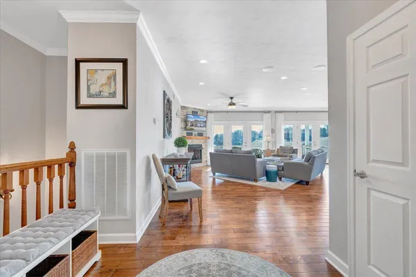 a living room with furniture a fireplace and a chandelier