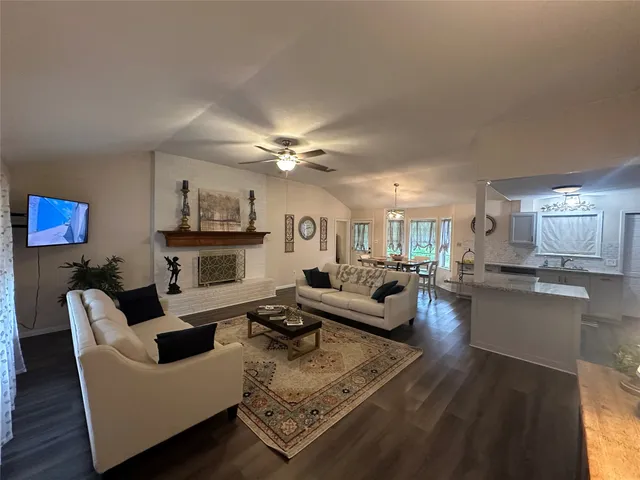 a kitchen with stainless steel appliances granite countertop a refrigerator a stove and a sink