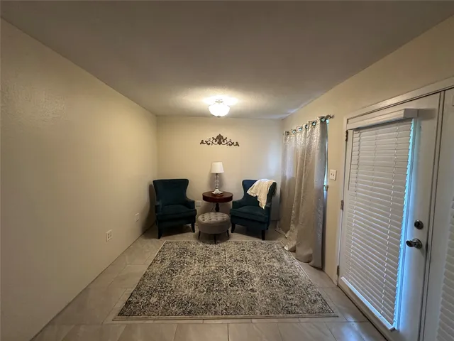a living room with furniture and a mirror