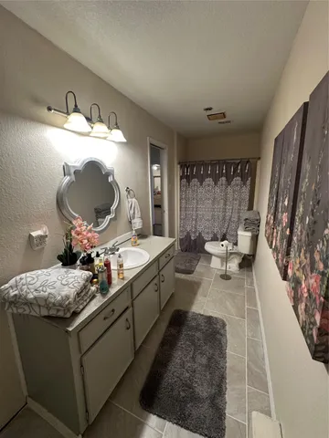 a utility room with a sink a mirror and a window